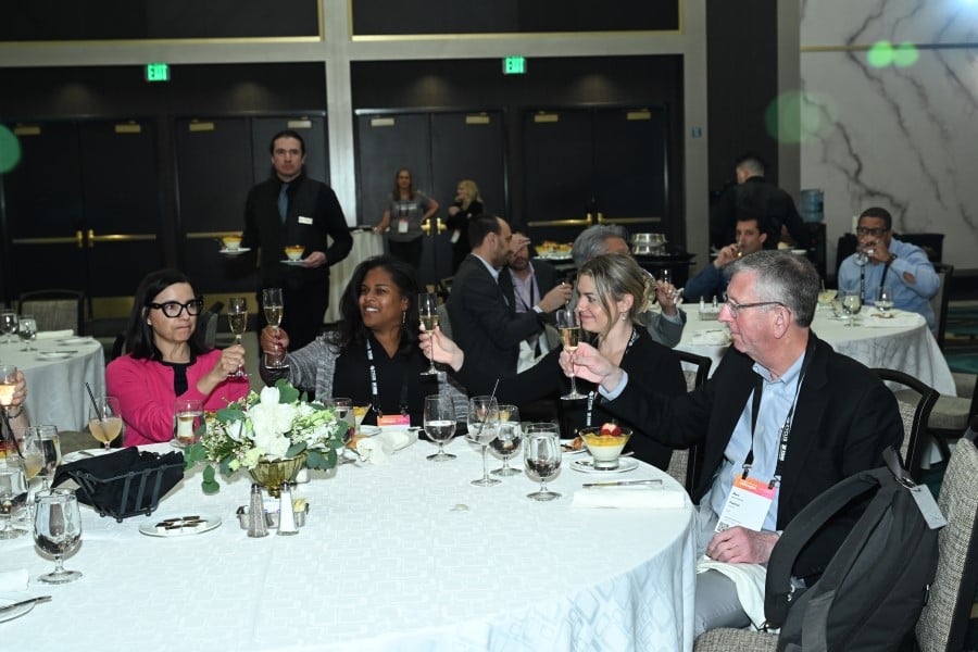 people at a table toasting